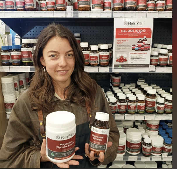 Naturopath holding NutriVital Magnesium Glycinate powder and capsules