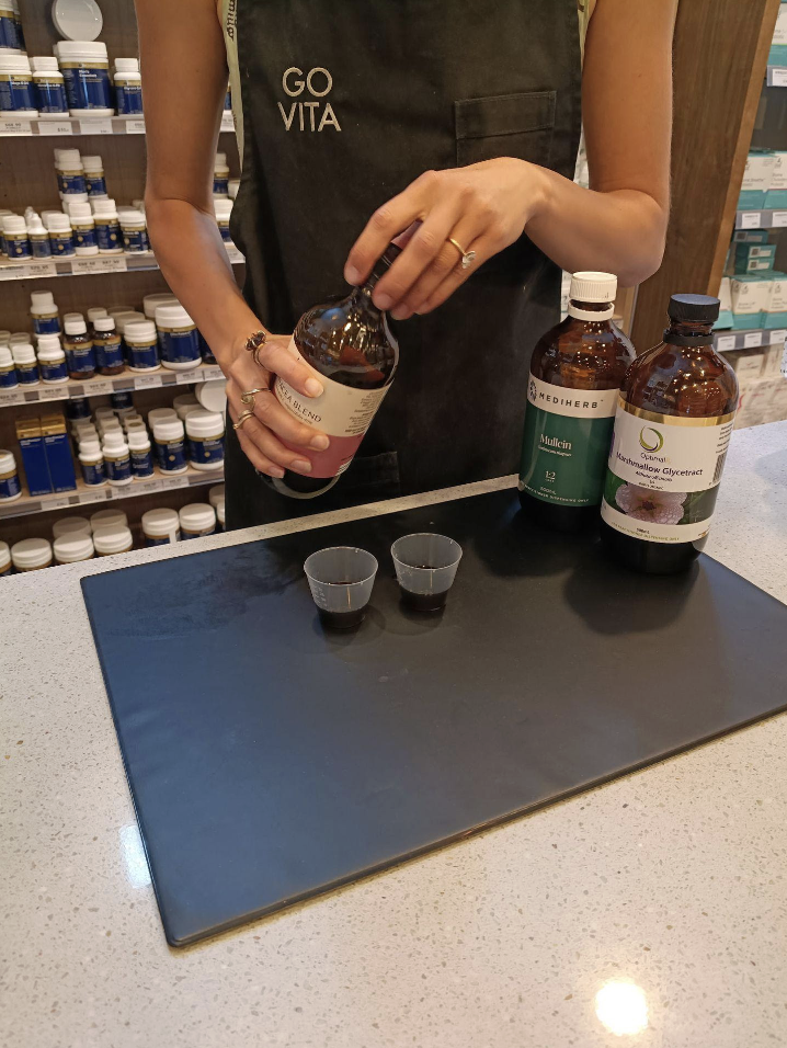 Go Vita naturopath dispensing a herbal tincture blend in store