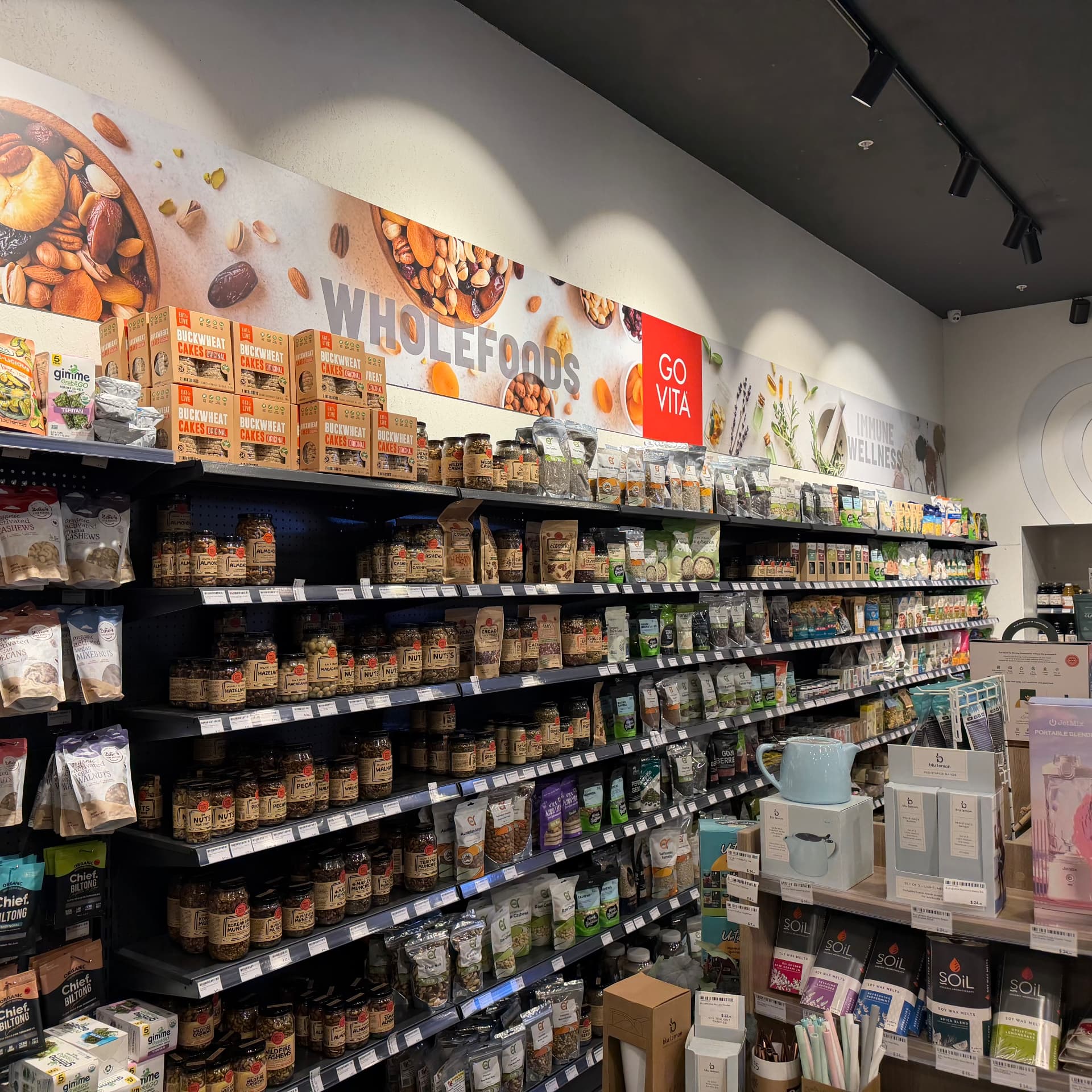 Wholefoods aisle: jars of nuts, seeds, dried fruit and superfood powders